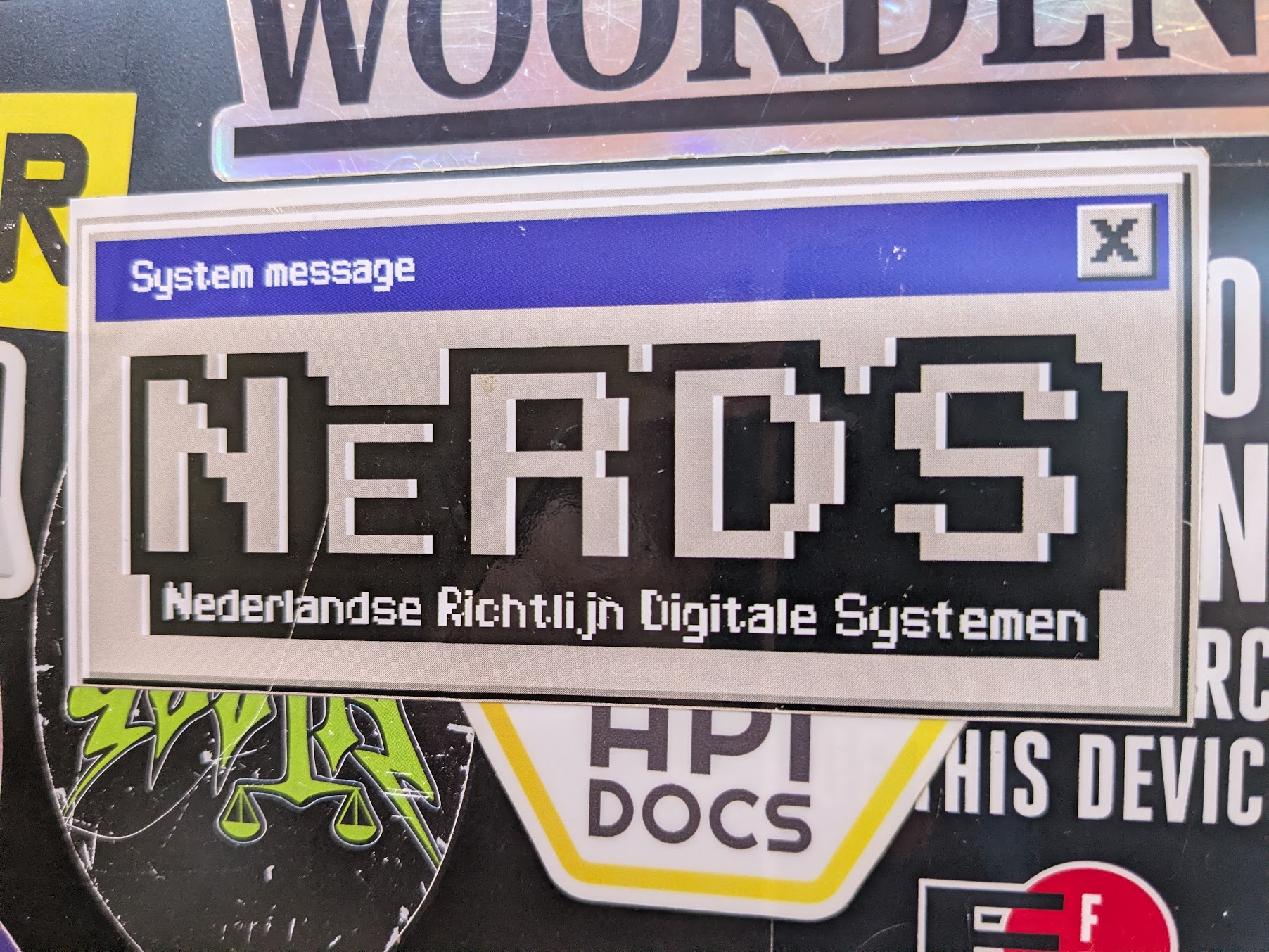 Een foto van een laptop met een sticker van NeRDS er op.